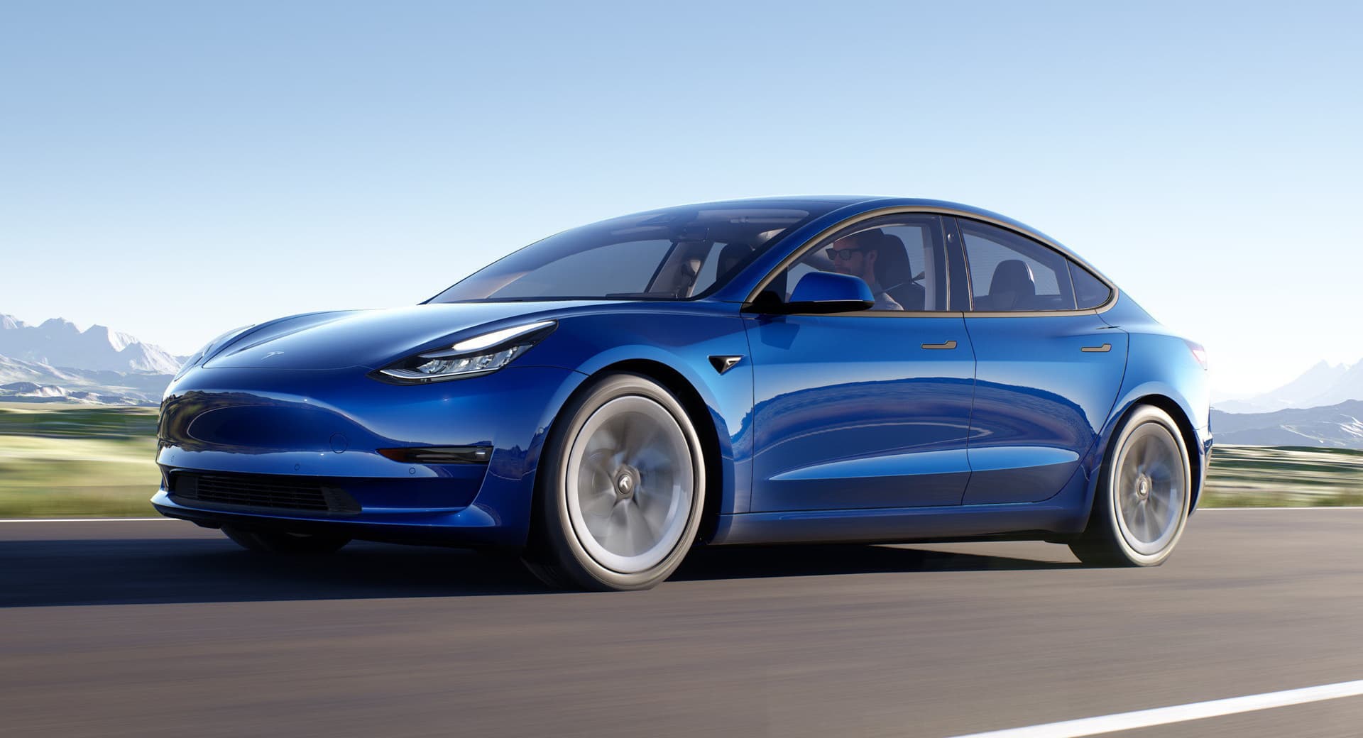 Blue Tesla Model 3 in motion